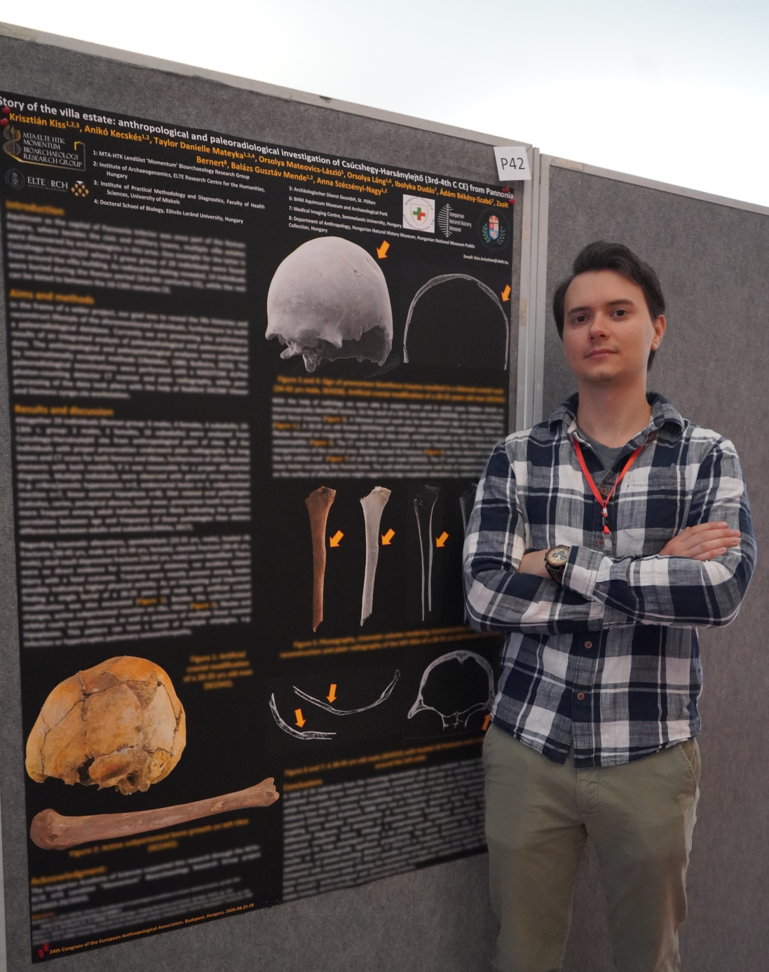 Krisztián Kiss standing next to his poster